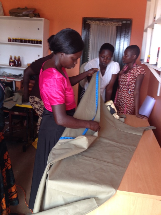 Women at work measuring materials to be cut