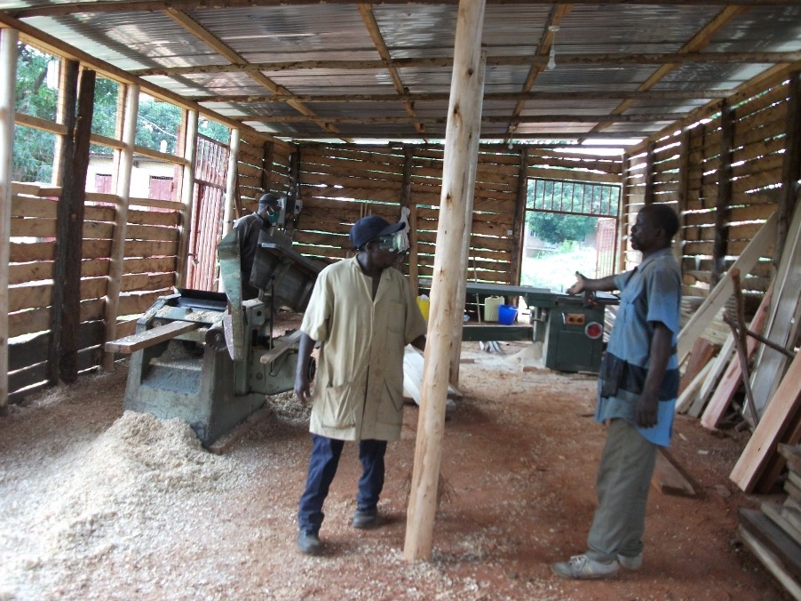 Staff discussing how to operate the two machines with support from BDMF funds