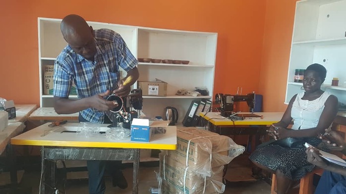 Trainer setting tailoring machines for training.